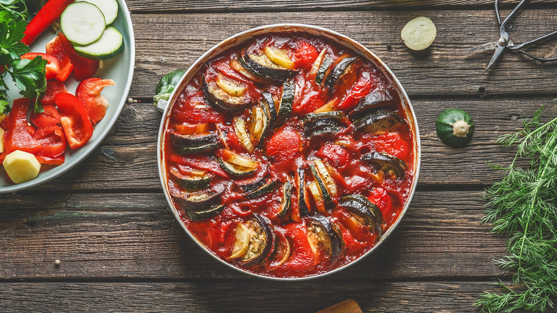 dish of French ratatouille surrounded by ingredients