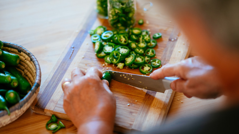 Woman slicing jalapeños