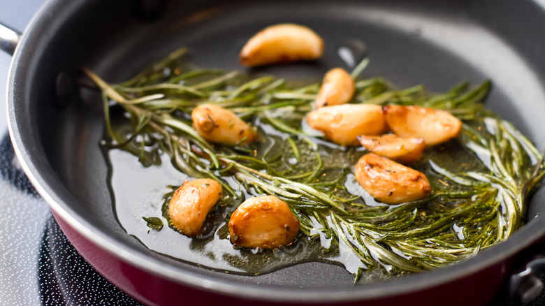 sauteeing garlic and rosemary in olive oil