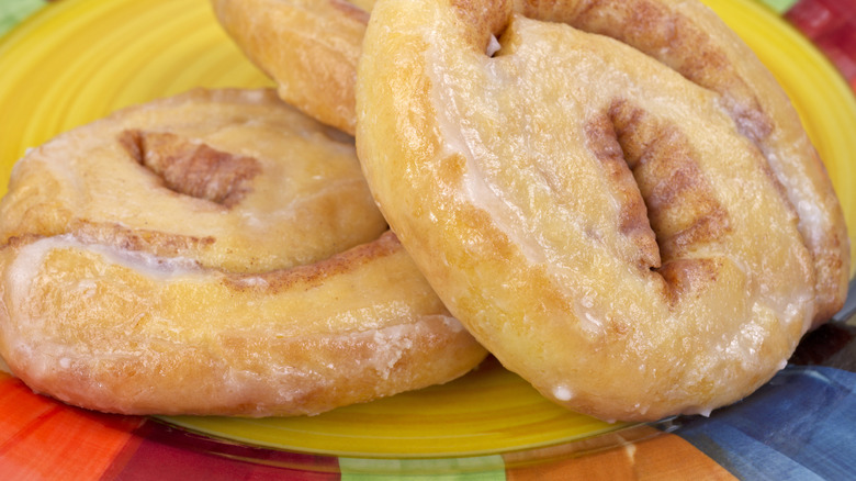 Honey buns on a yellow plate