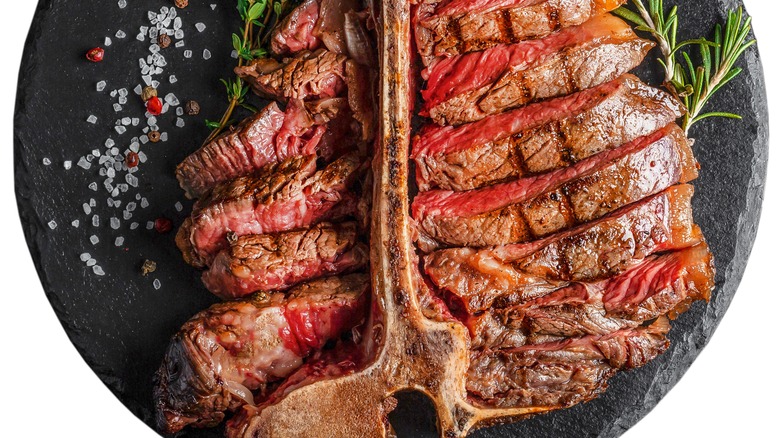 cooked porterhouse steak on a marble slab