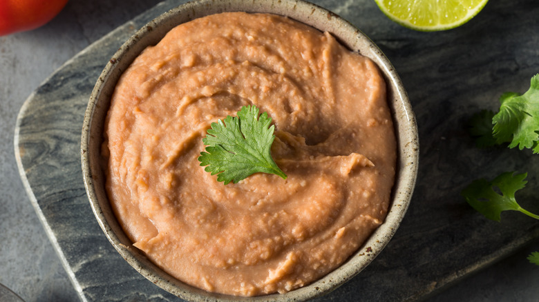 Refried beans in bowl with cilantro