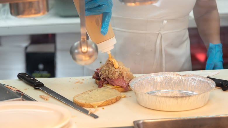 chef making Reuben sandwich