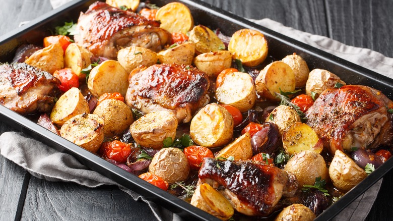 chicken, potatoes, tomatoes on sheet tray