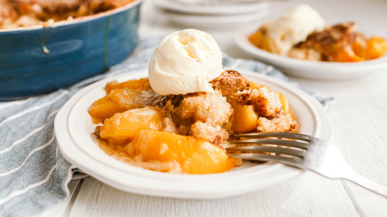 Peach cobbler on white plate