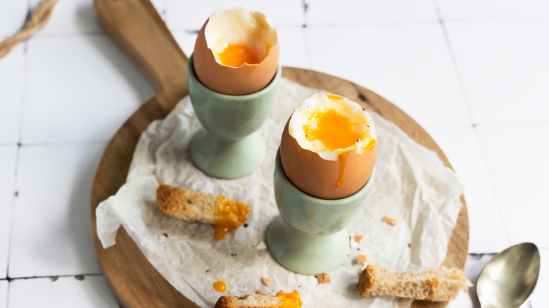 tray with soft boiled eggs and strips of toast