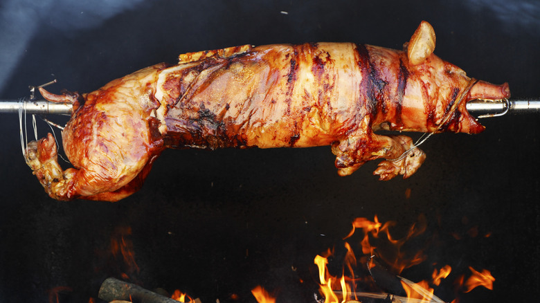 A whole pig roasting on a spitfire
