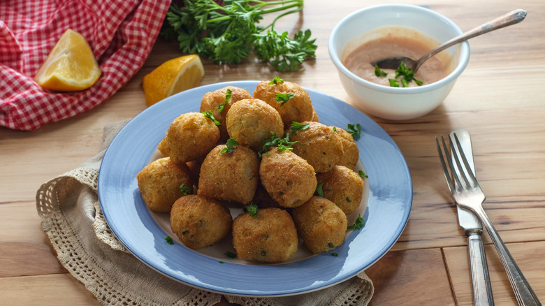 Hush puppies on plate with dip