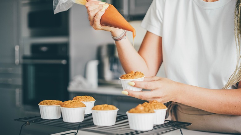 Filling cupcakes with piping bag 