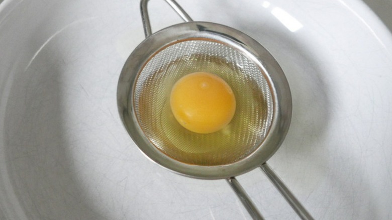 an egg in a strainer