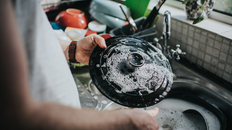 person cleaning cast iron