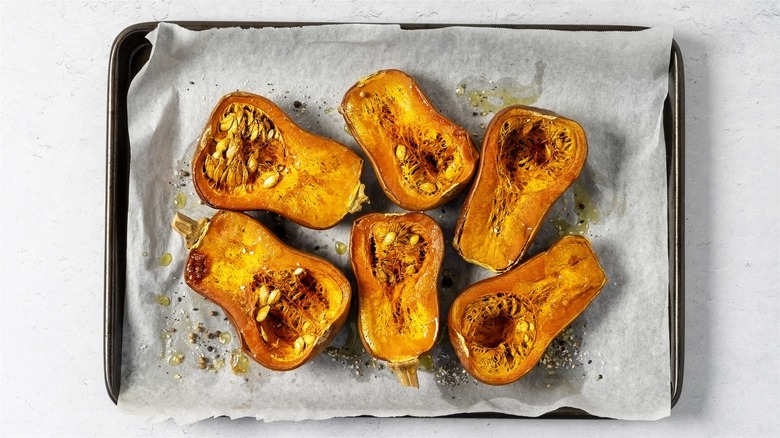 Roasted butternut squash halves on a tray