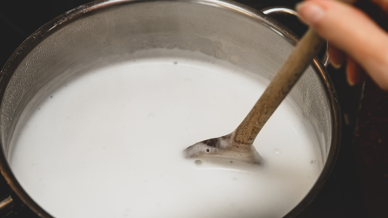 stirring milk in a pot