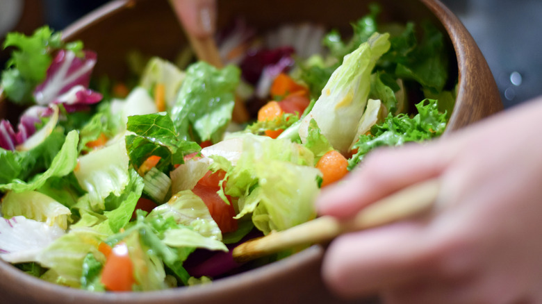 Close up of a salad being tossed