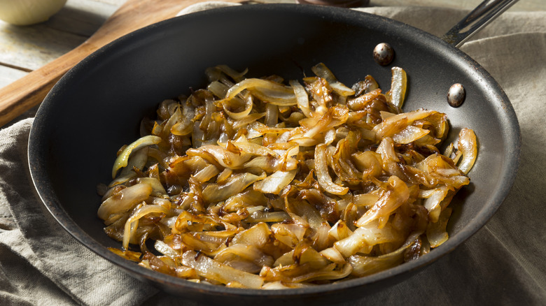 Caramelized onions are displayed in a non-stick pan.