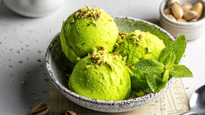 bowl of ice cream with crushed nuts on top