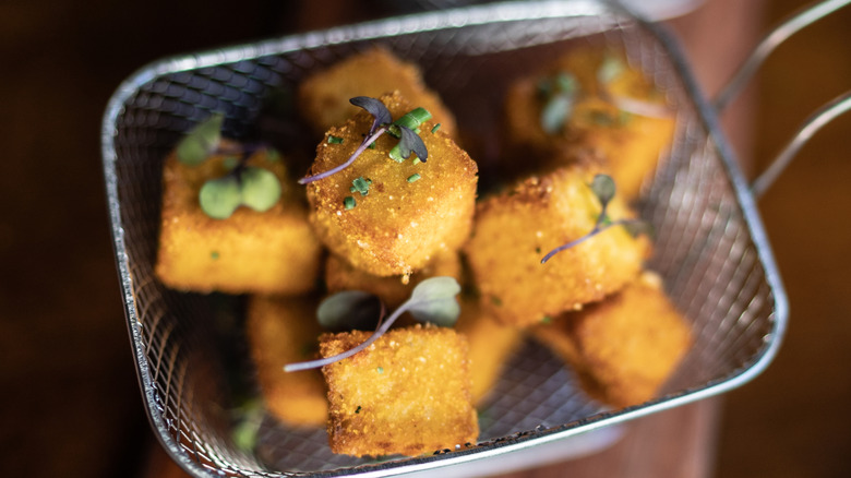 cubes of fried grits garnished with microgreens