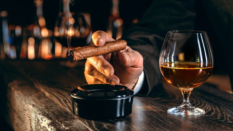 Glass of brandy with cigar