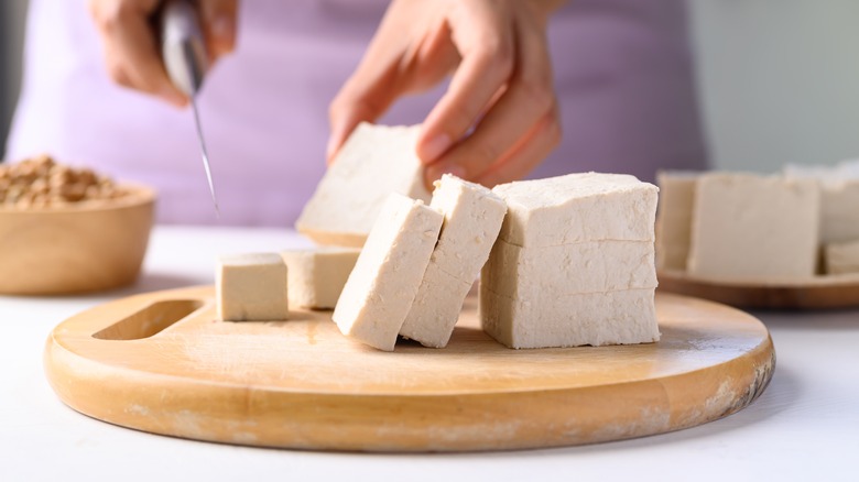 Cutting slices of tofu
