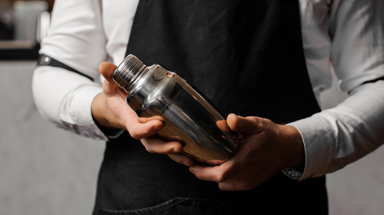 Close-up of cocktail shaker in hands