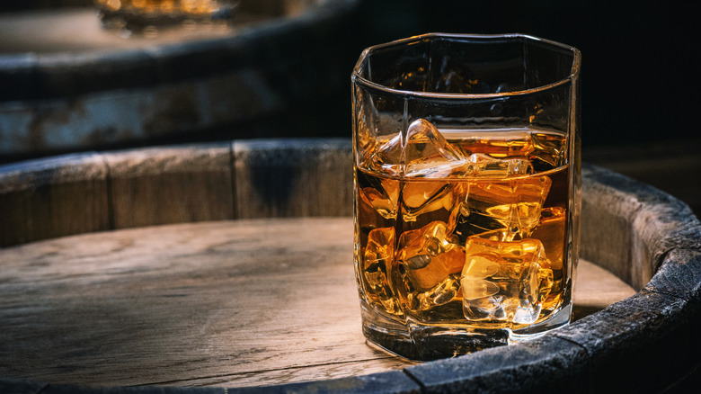 Glass of whiskey on an old barrel