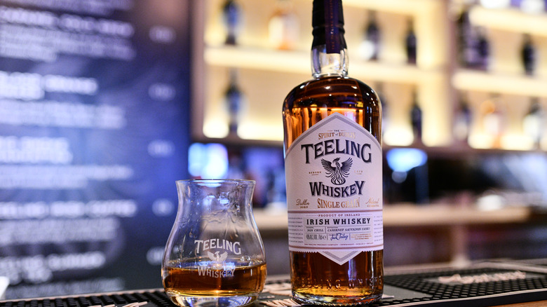 Bottle and glass of Teeling on the bar at the distillery