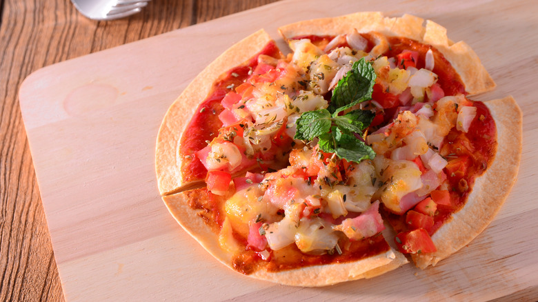 Tortilla pizza on cutting board