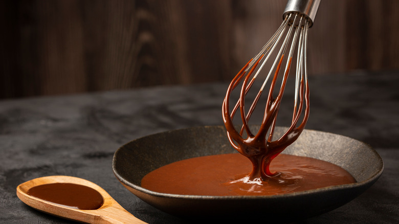 whisk stirring bowl of chocolate ganache 