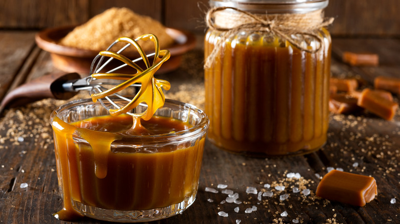 caramel sauce in jars with whisk