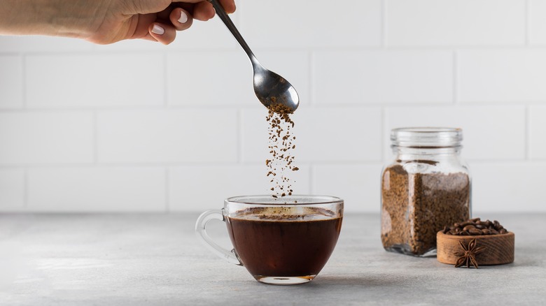 Home cook stirring instant coffee into steaming water