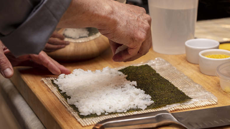 chef preparing maki roll