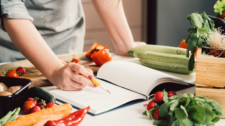 checking cookbook recipe and ingredients