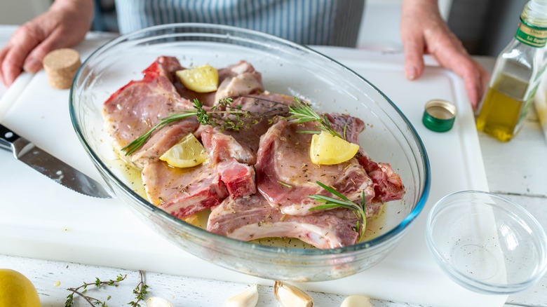 Pork chops marinating in bowl