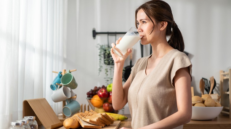 Woman drinks glass of milk