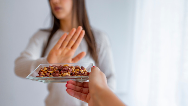 woman turning away peanuts