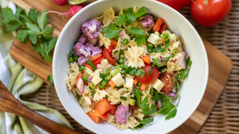 A bowl of pasta salad with broccoli