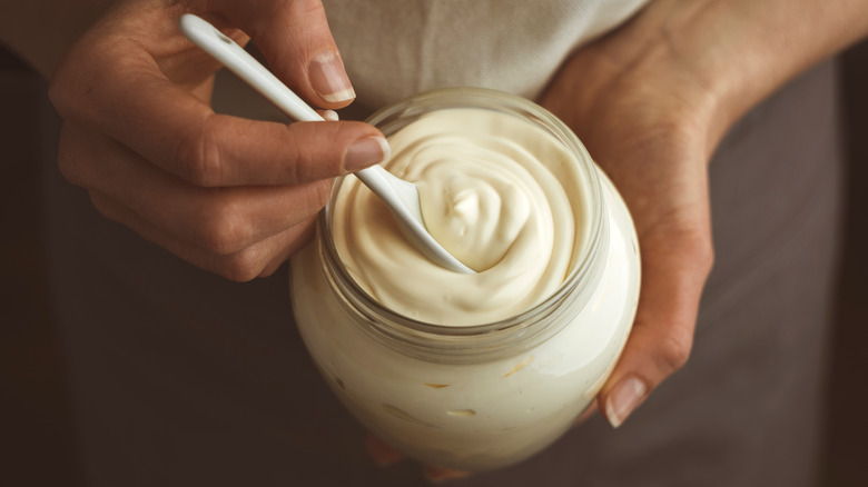Mayonnaise in jar with spoon