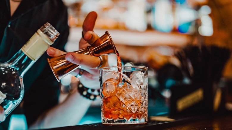 Bartender mixing a Negroni drink