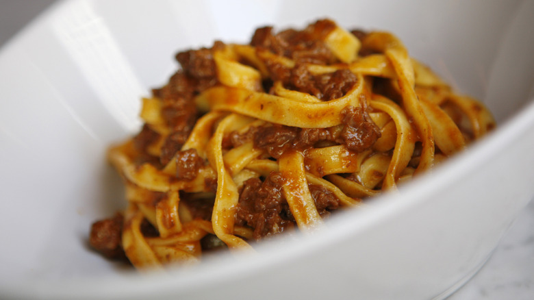 tagliatelle bolognese in white bowl