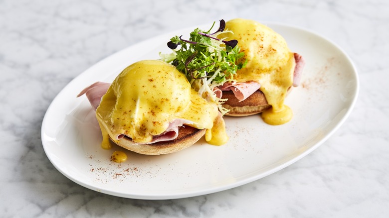 Eggs benedict on a white plate