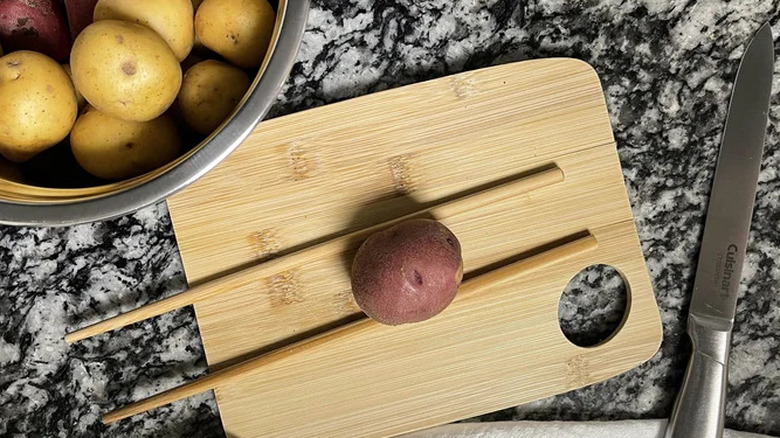 New potatoes on cutting board with chopsticks 