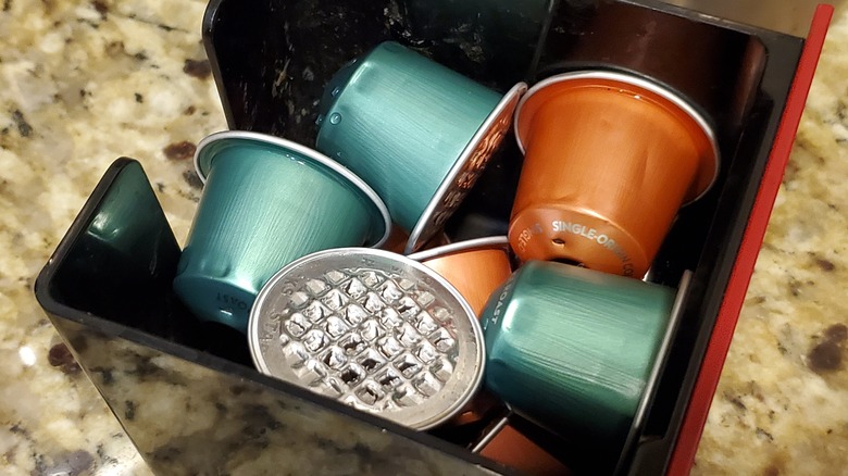 used Nespresso pods in container