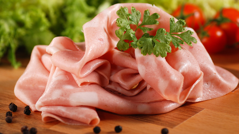 sliced mortadella on a cutting board