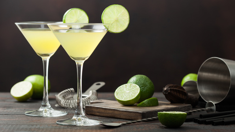 two martini glasses with limes