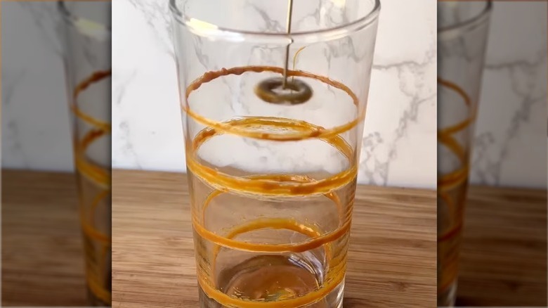 frothing chocolate rings onto glass