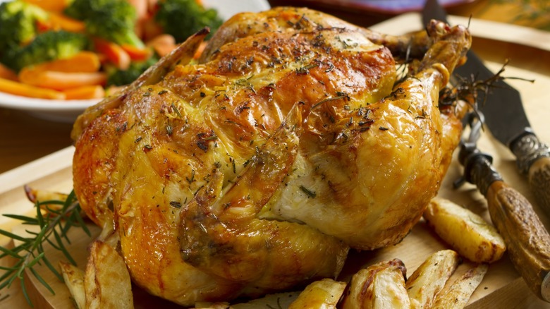 roast chicken on cutting board 