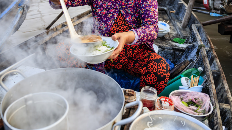 woman serving Vietnamese noodle soup