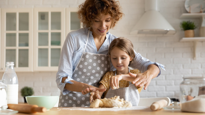 woman and girl baking cookies