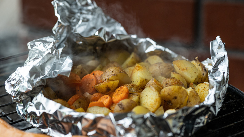 roasted potatoes and carrots in a foil pack