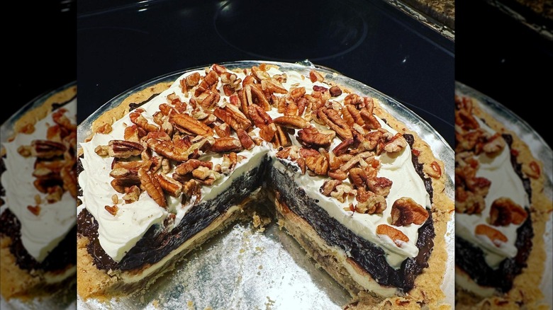 whole possum pie with distinctive layers of crust, cream, chocolate custard, whipped cream, and pecans